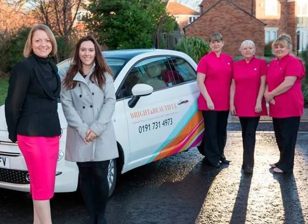 housekeeping team next to a Bright & Beautiful branded car